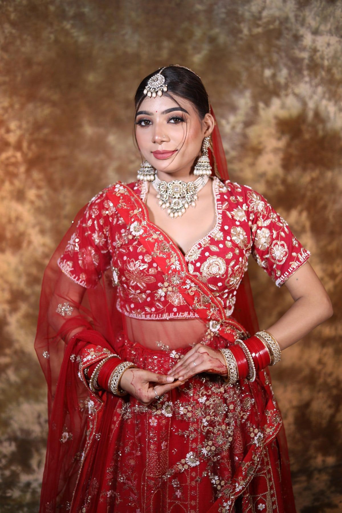 Full-length bridal look with red lehenga and kundan jewellery, Faridabad