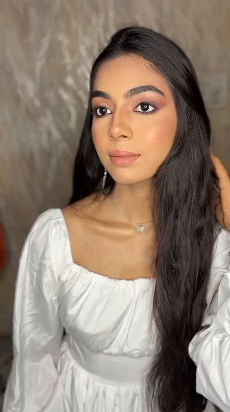 Side profile of soft-glam makeup with highlighted cheekbones
